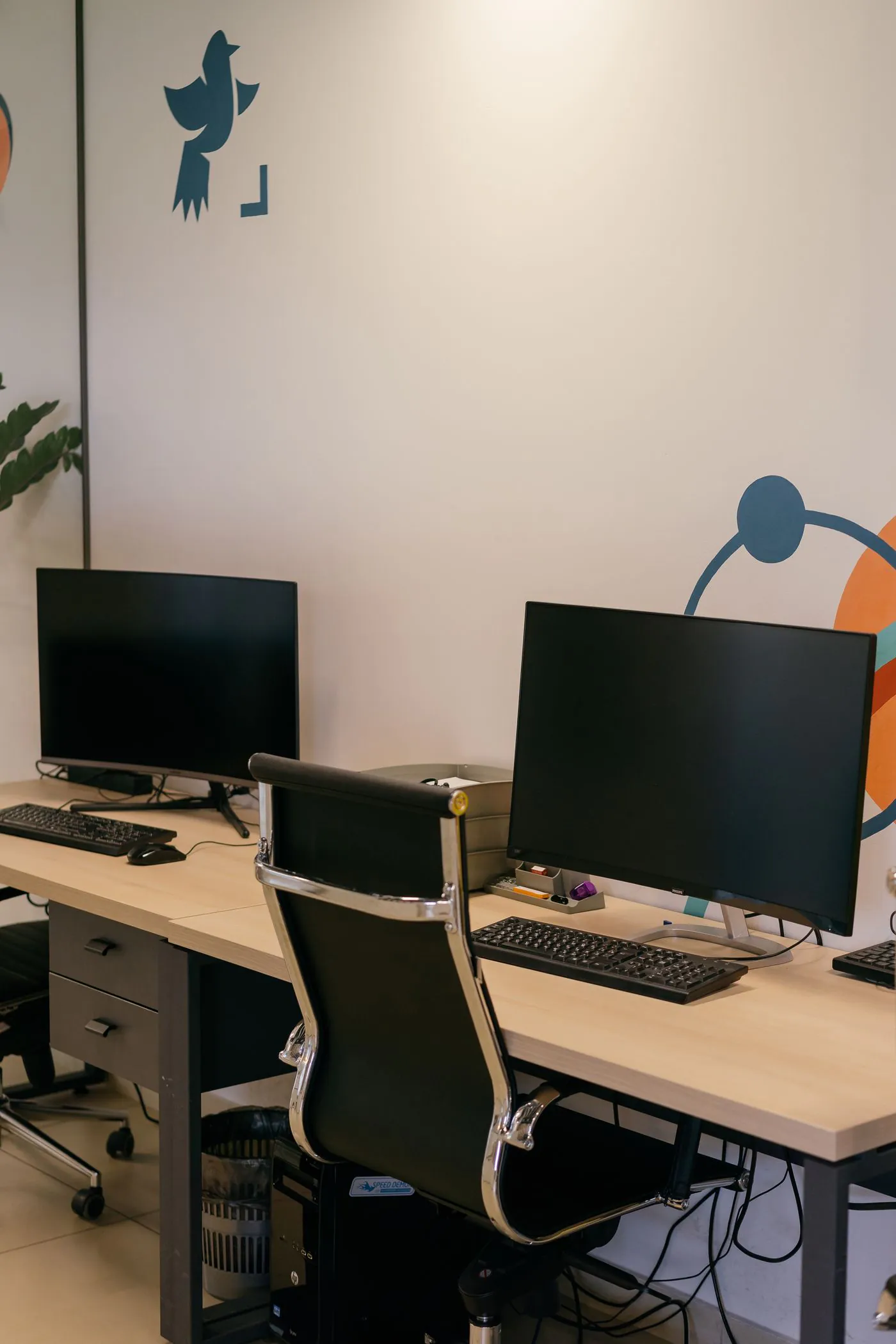 An index trading desk with S&P 500 and Nasdaq-100 charts across several screens
