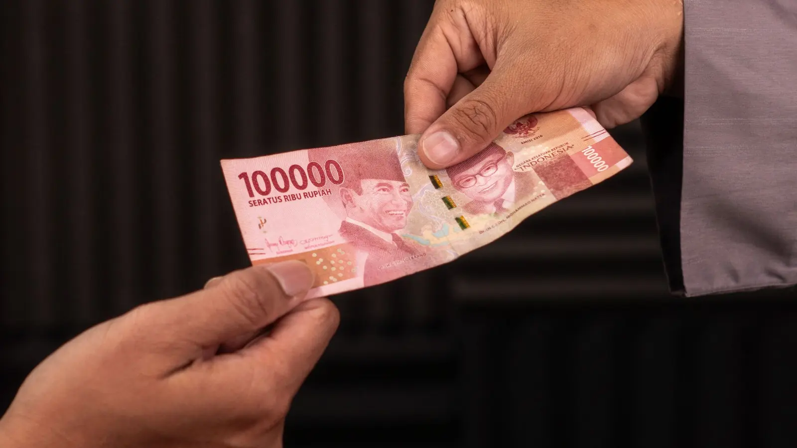 Banknotes changing hands across a counter