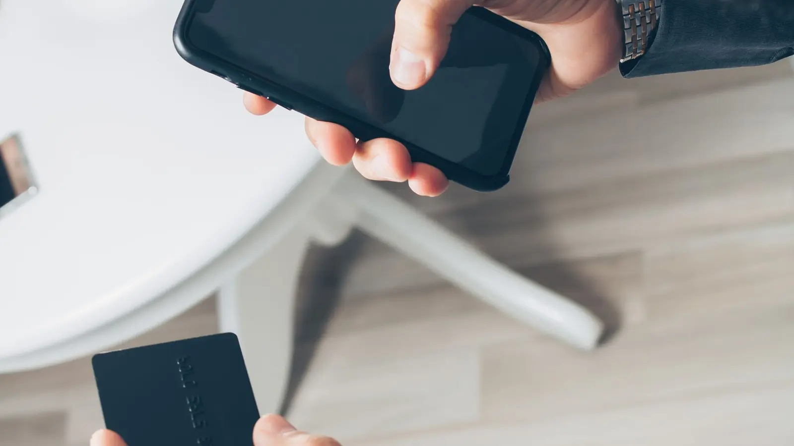Two hands holding smartphones side by side