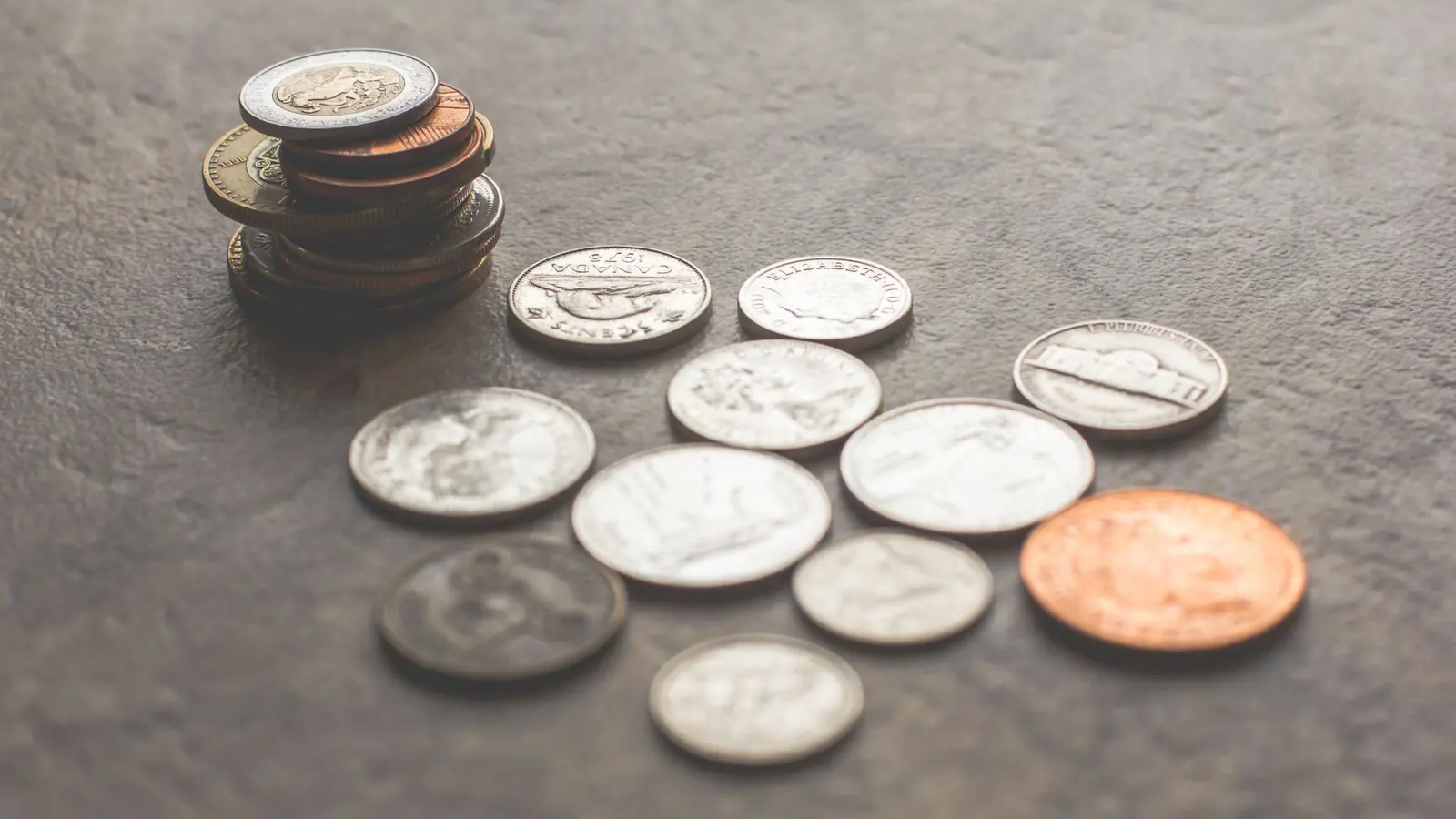 Coins scattered on a grey table