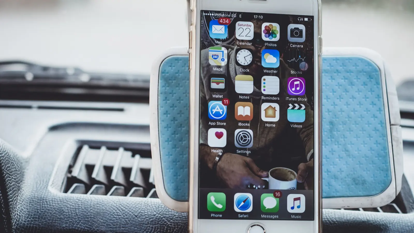 A phone lit up with app notifications resting on a keyboard