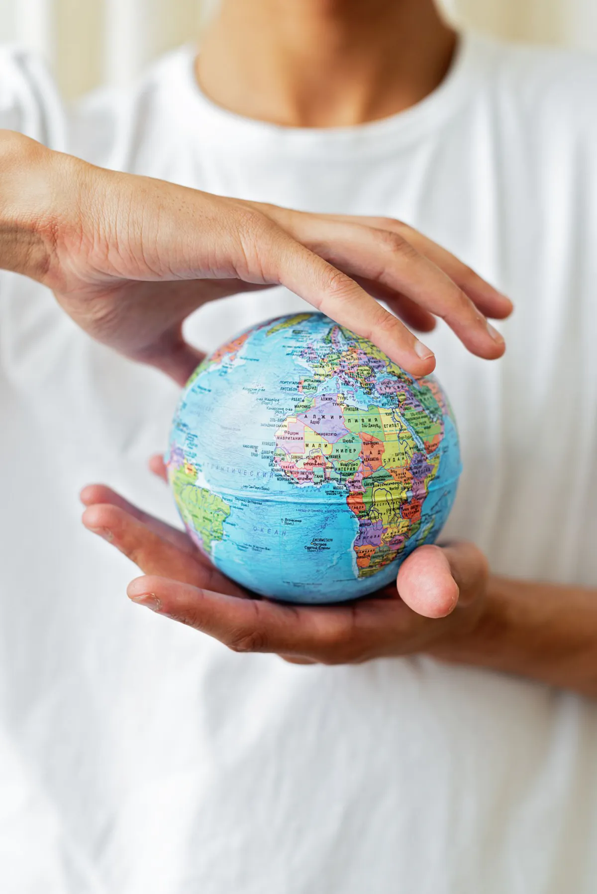 A hand holding a globe, representing forex trading around the world
