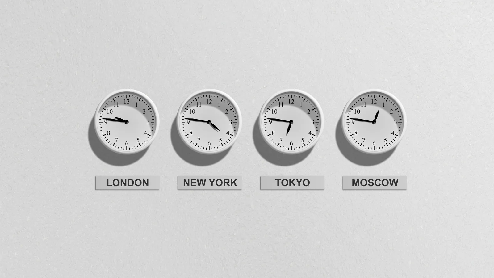 Four wall clocks labelled London, New York, Tokyo and Moscow