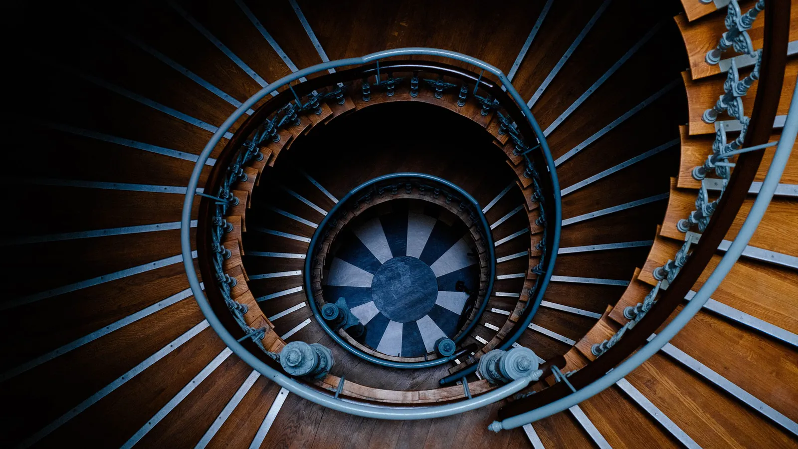 Looking down a spiral wooden staircase with evenly spaced steps