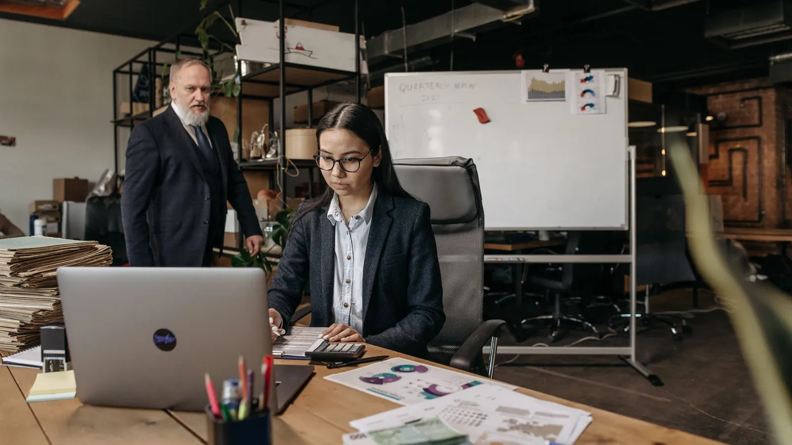 Two colleagues reviewing work together in an office