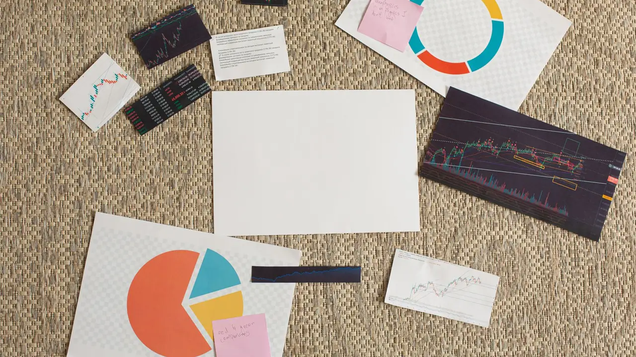Printed charts and graphs spread across a table