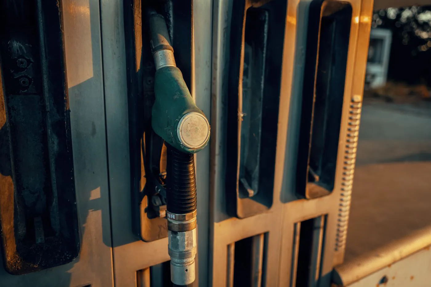 A fuel pump nozzle at a filling station, representing refined-product demand