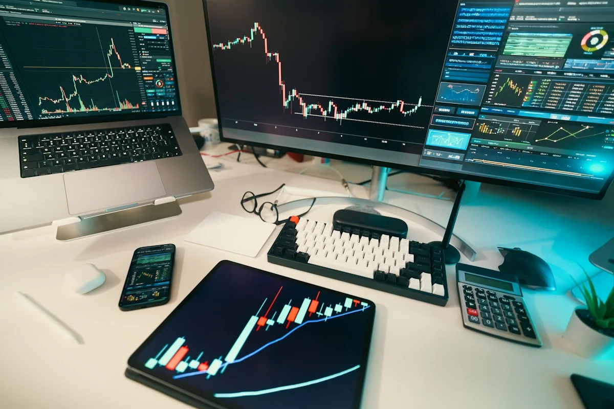 Crypto trader monitoring real-time charts on multiple screens with drawdown metrics visible