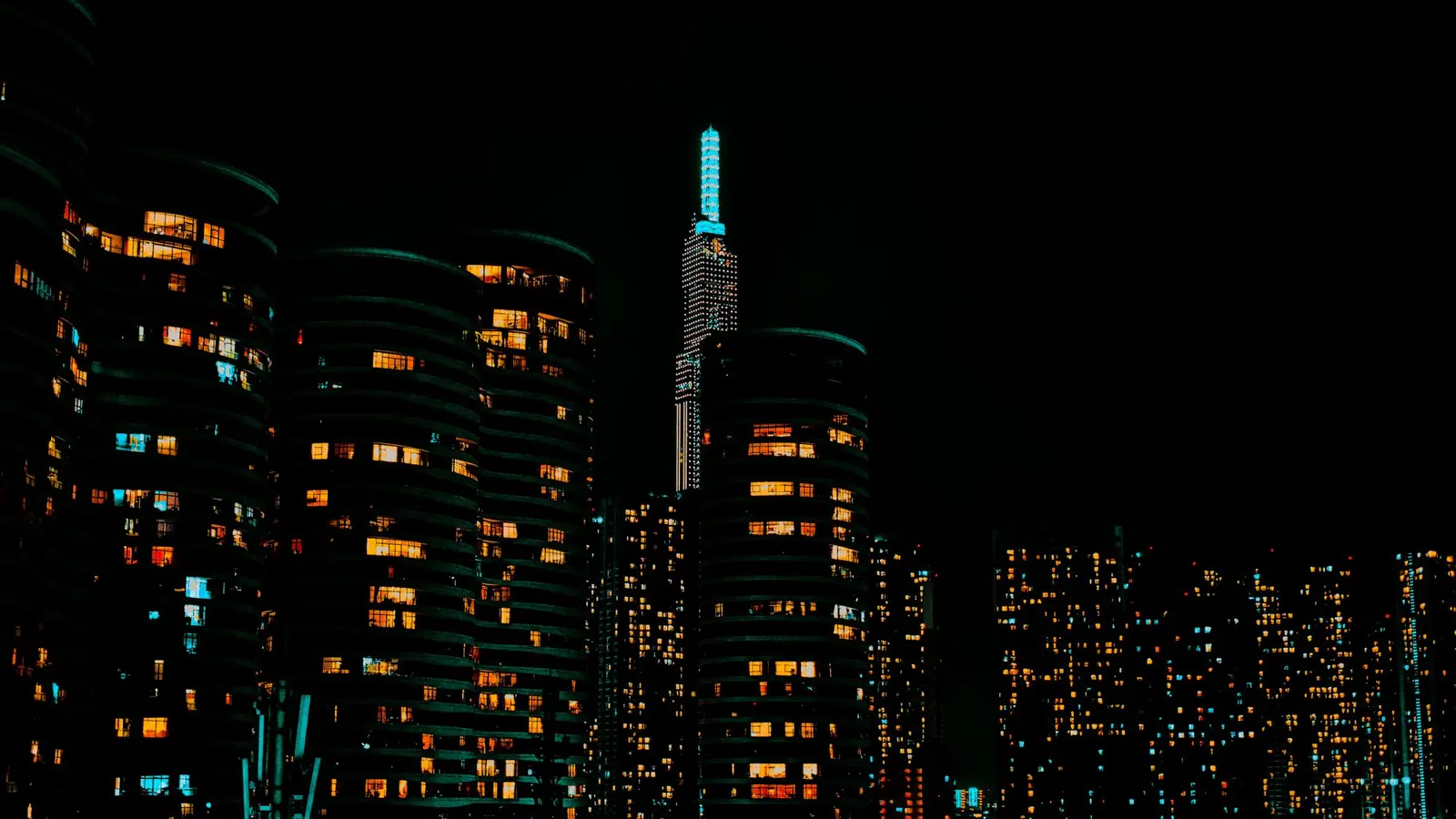 A city skyline at night with lit towers