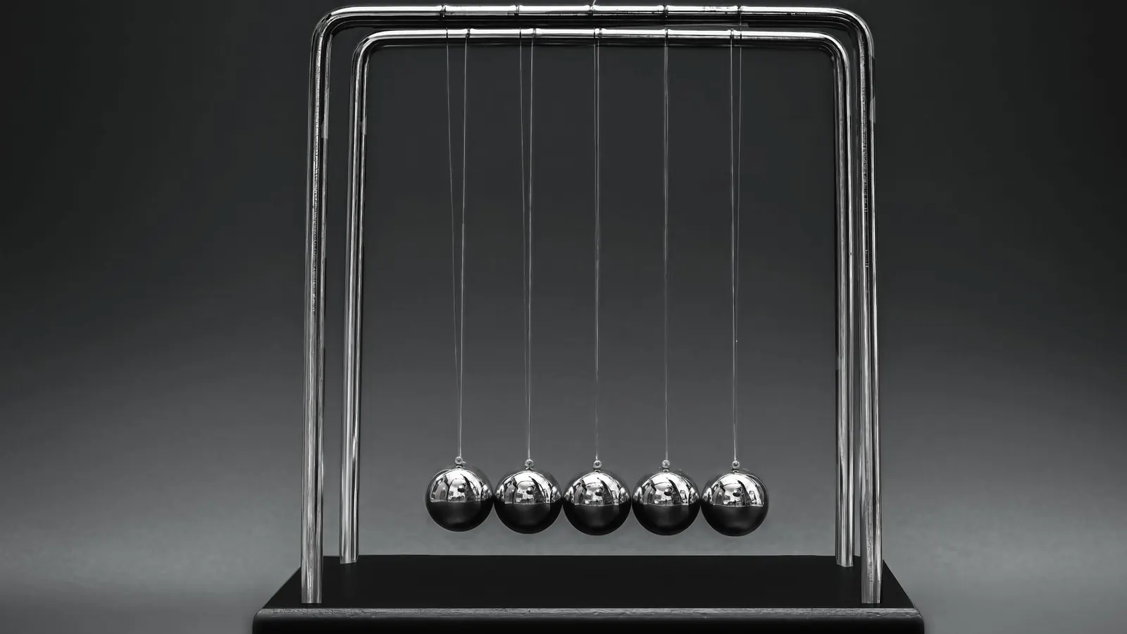 A Newton's cradle with steel balls at rest