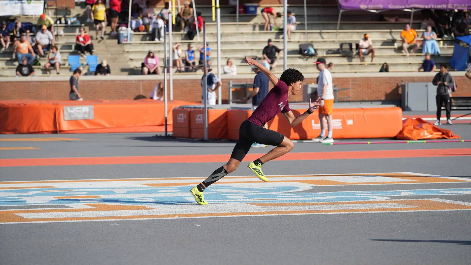 A sprinter accelerating on an outdoor running track