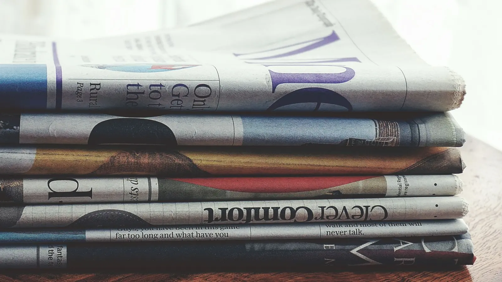 A stack of financial newspapers