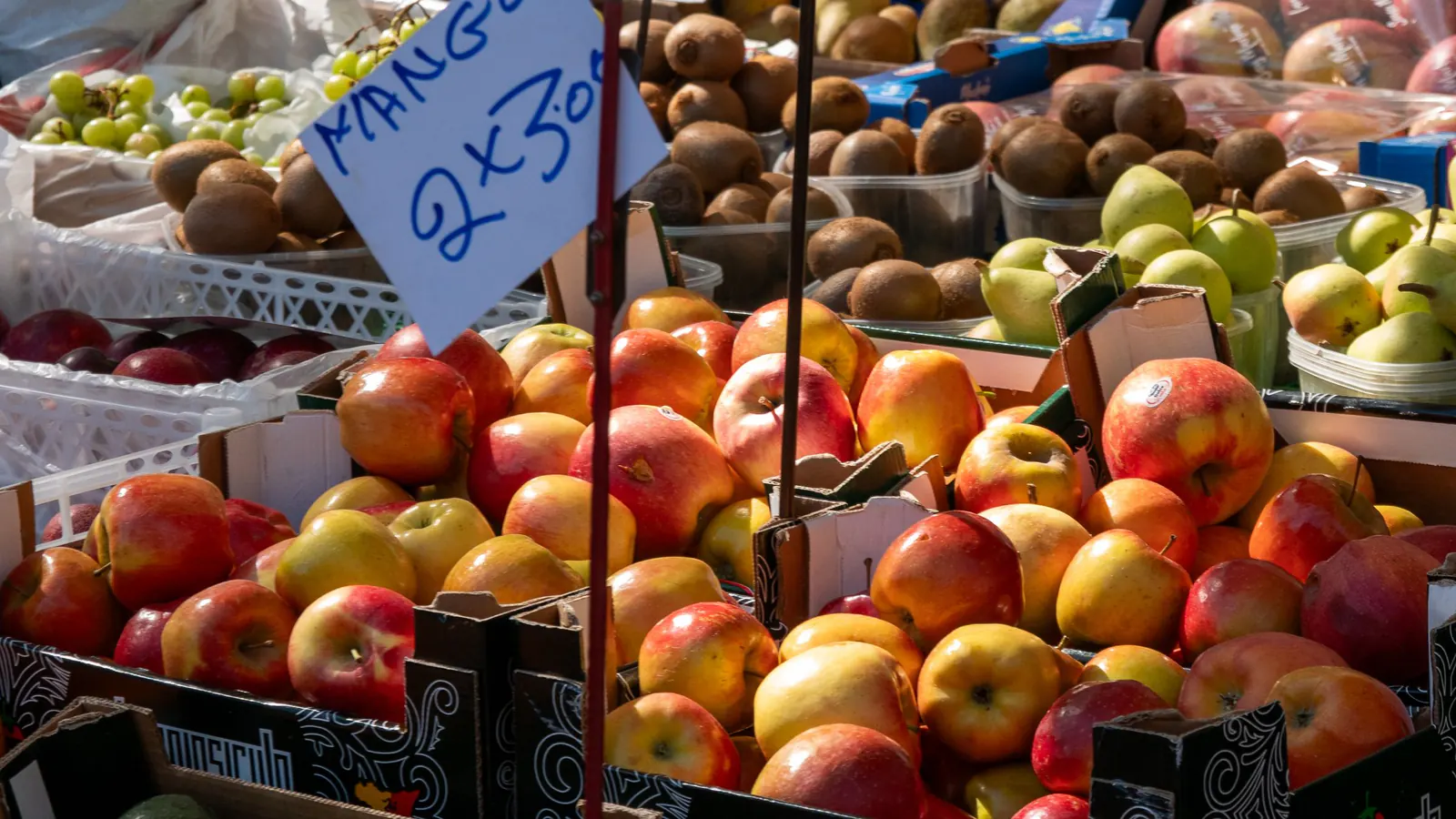 Crates of fresh fruit piled high on a market stall